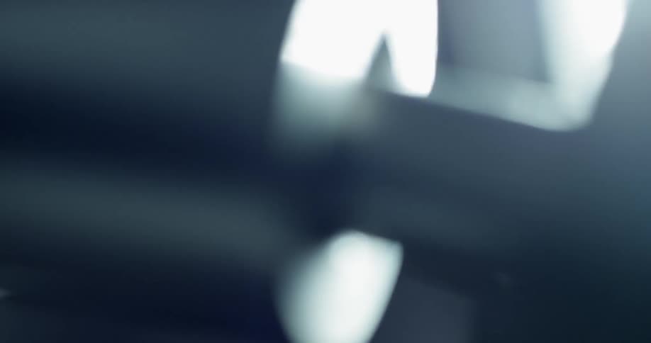 Close up of a piston moving with a light behind it