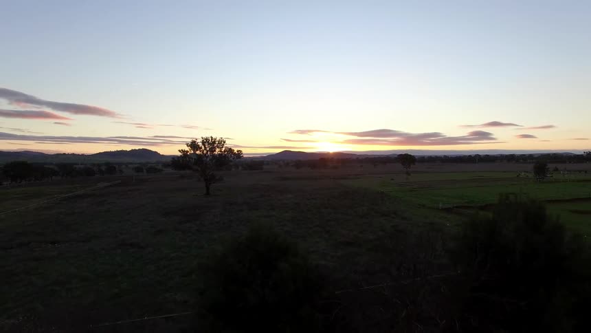 The sun is setting on a large field