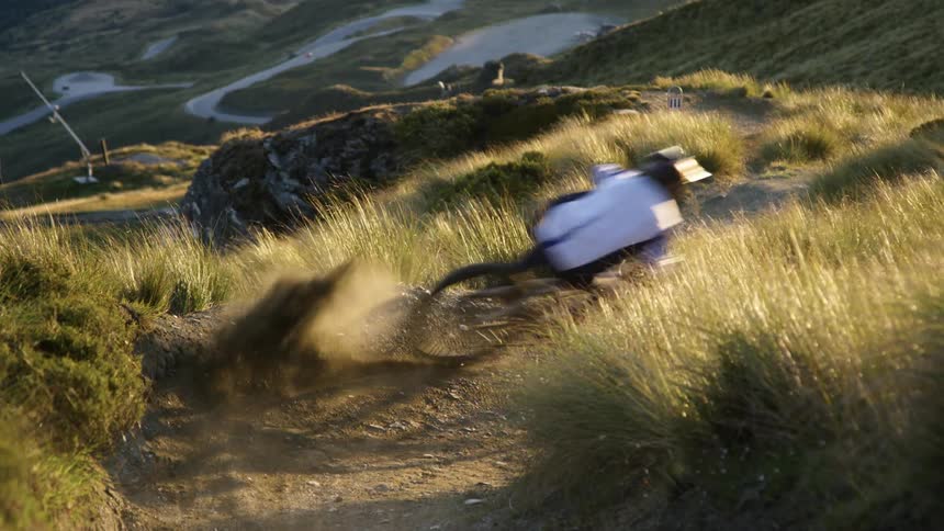 A male mountain bikes down a hill