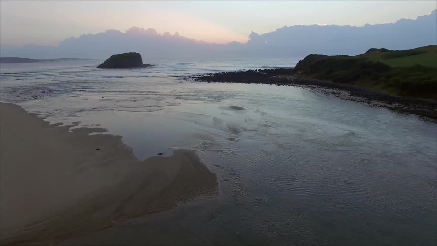 The sun is setting on the beach