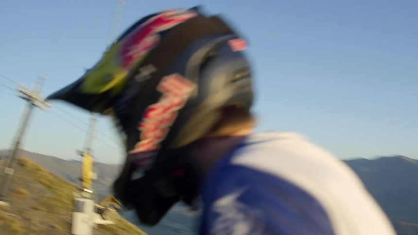 A white guy pushes a mountain bike up a steep path on a hill