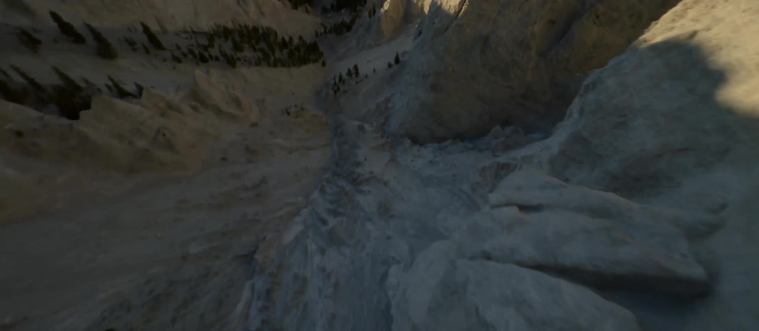 Aerial view of a valley between steep mountains andwide field against the blue sky