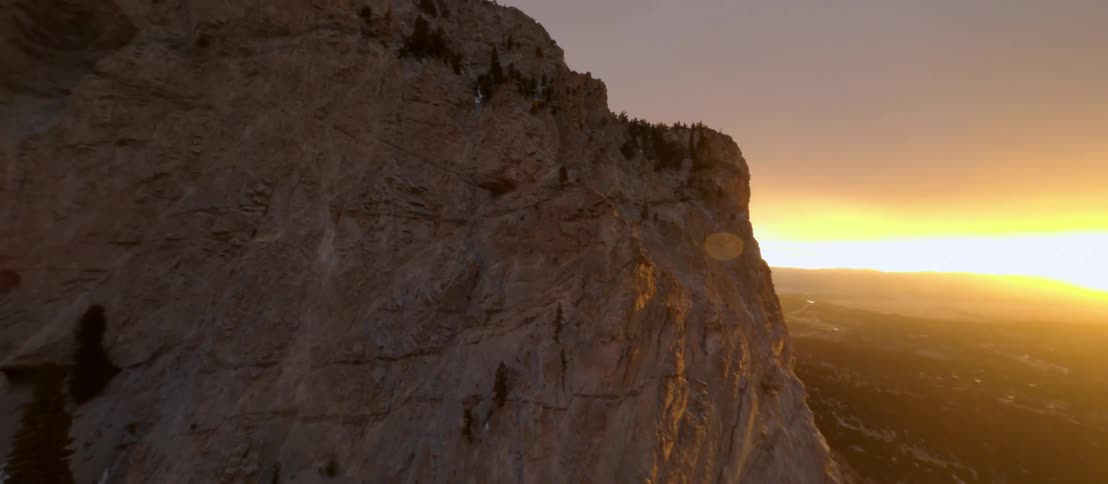 Aerial view of a rocky mountain and the sun going down