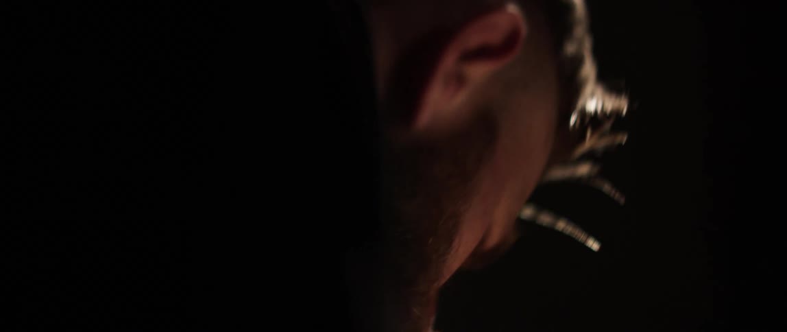A white man looks down as he works
