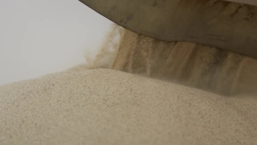 Sand pouring out of a machine
