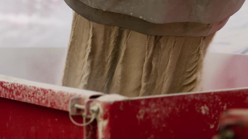 Cement being poured out of a machine