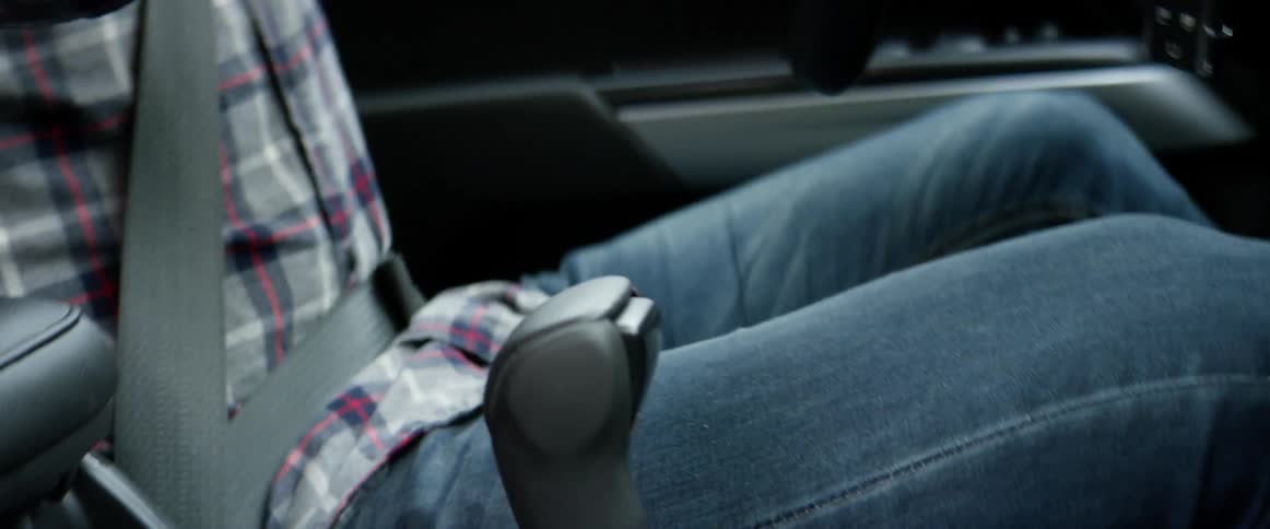 A man shifts his car as he drives