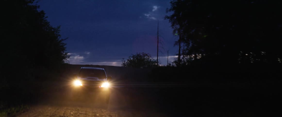 A vehicle drives over the hill
