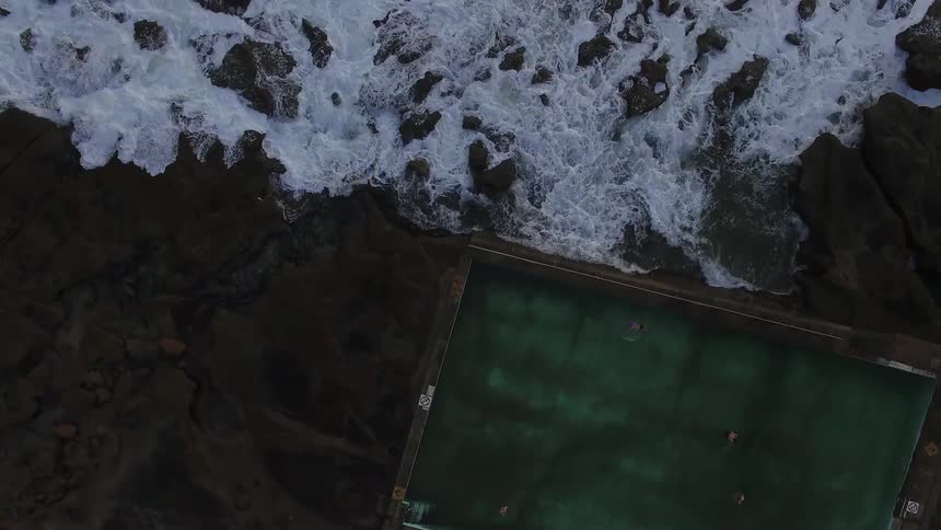 Ocean waves wash onto a rocky beach