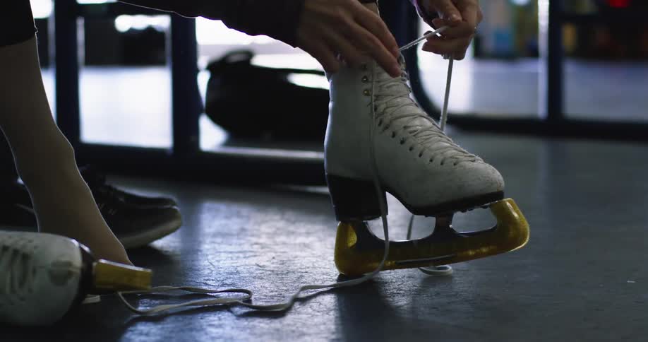 A woman puts on figure skates
