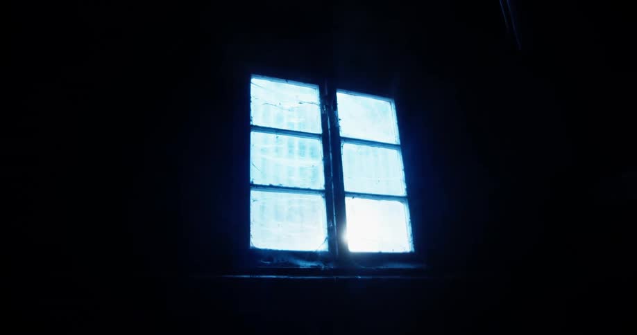 Sunlight comes through the window in a dark room