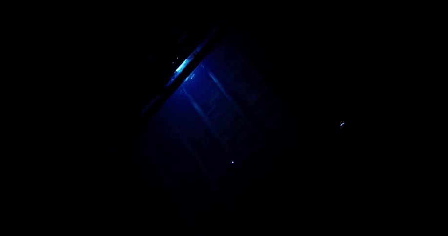 A flare shining through a skylight in a dark room