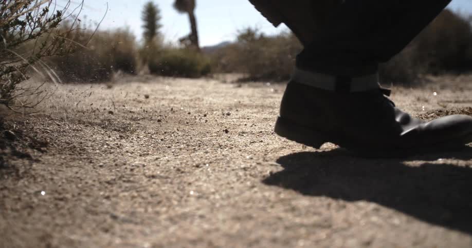 Person runs through the desert at day