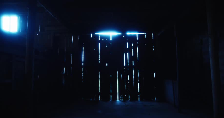 Light peaks into the pitch black barn