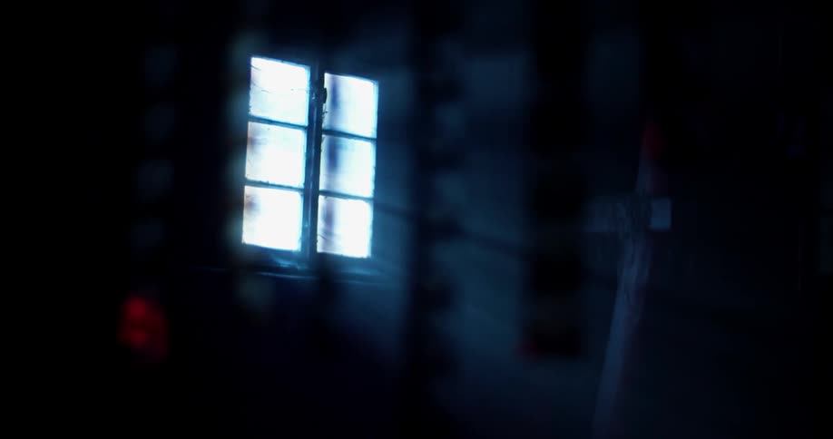Sunlight comes through the window in a dark room