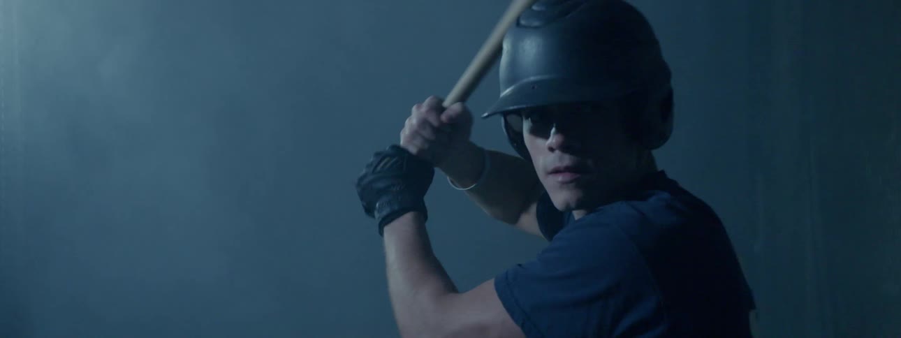 Batter grips bat ready to swing as fog floats behind him
