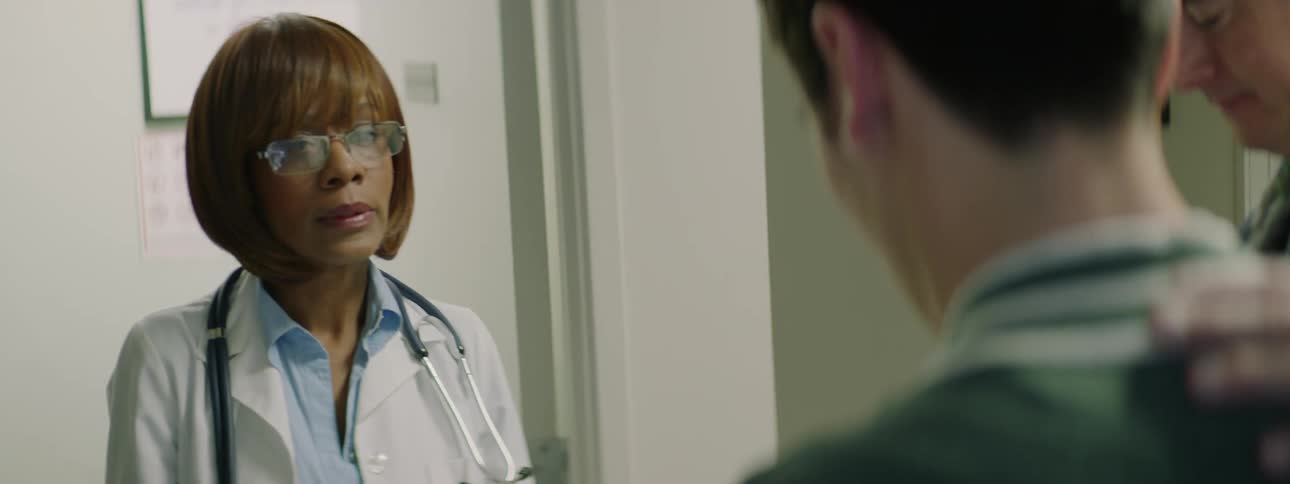 A black female doctor speaks to two white males