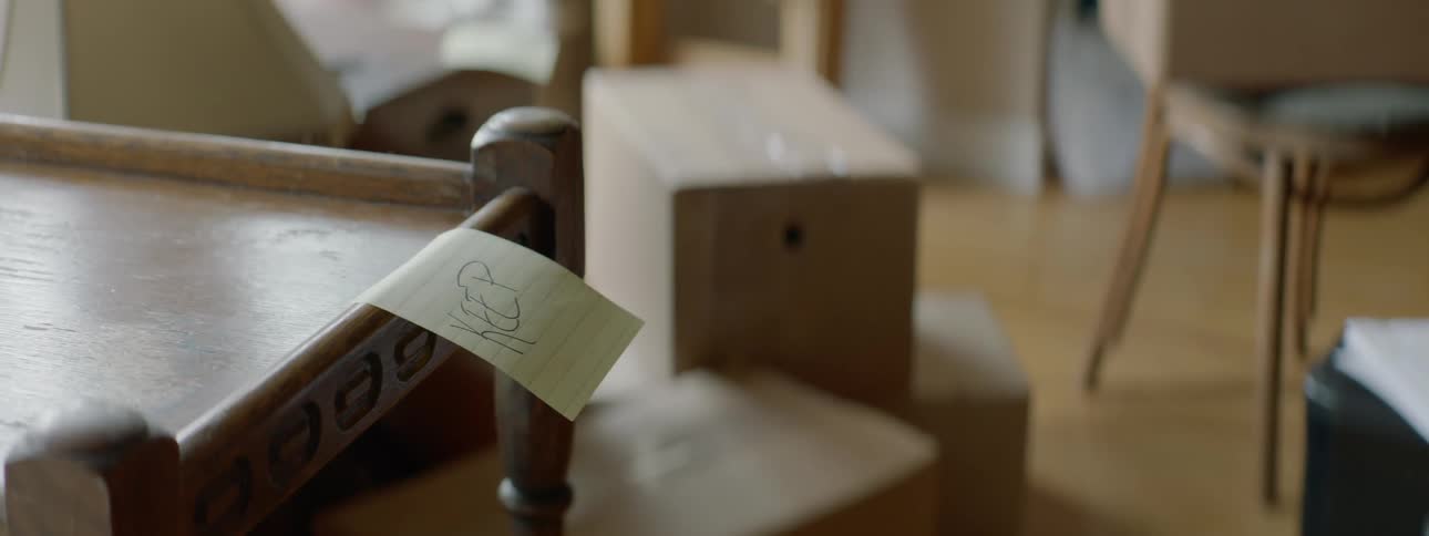 Male wanting to keep a wooden table so he labels it with a post it note