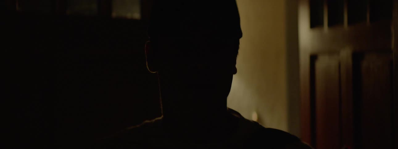 Teenager looks around a room then turns out the light and closes the door as he leaves
