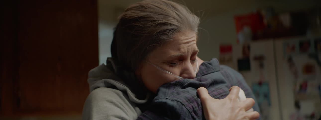 Woman hugs a man while she has oxygen tubing attached to her nose