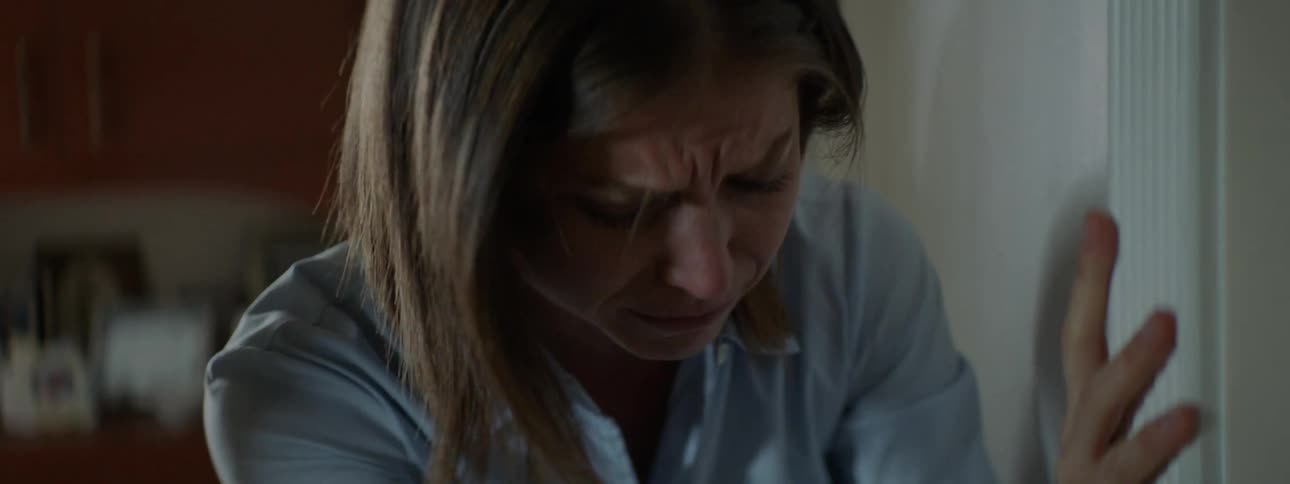 Woman coughs strongly leaning against wall