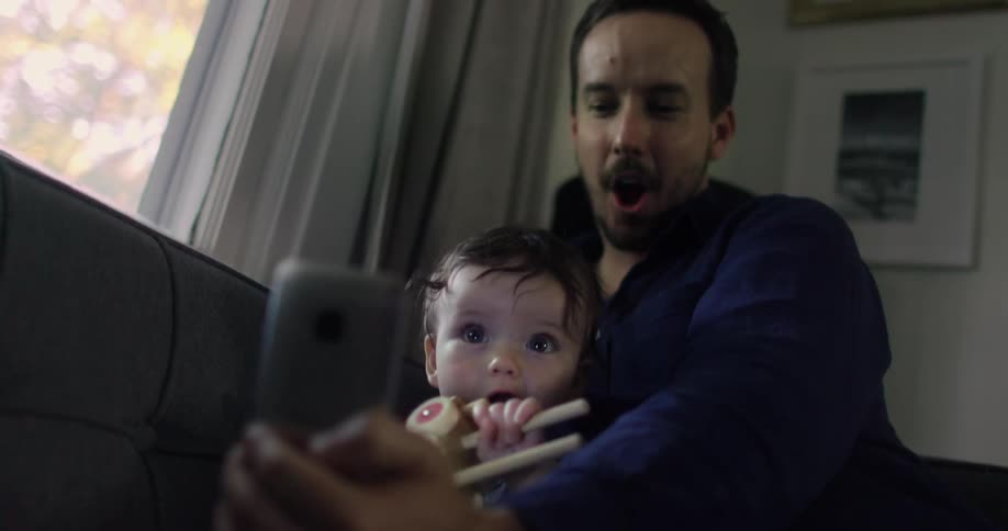 A dad takes a selfie with his son