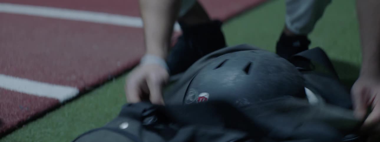 A man is grabbing a helmet out of bag