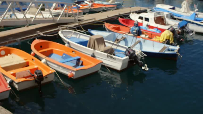 Boats are parked by a dock in the water