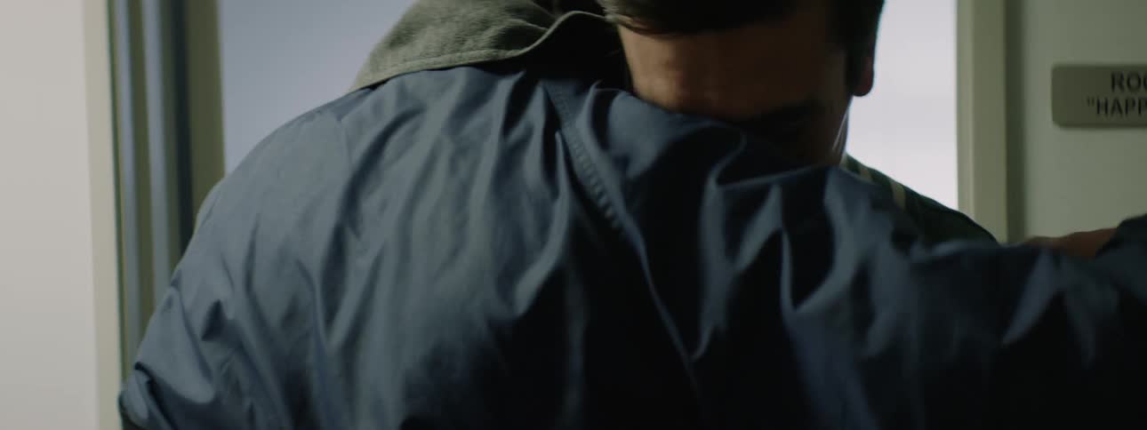 Father consoling and hugging his distressed teenage son