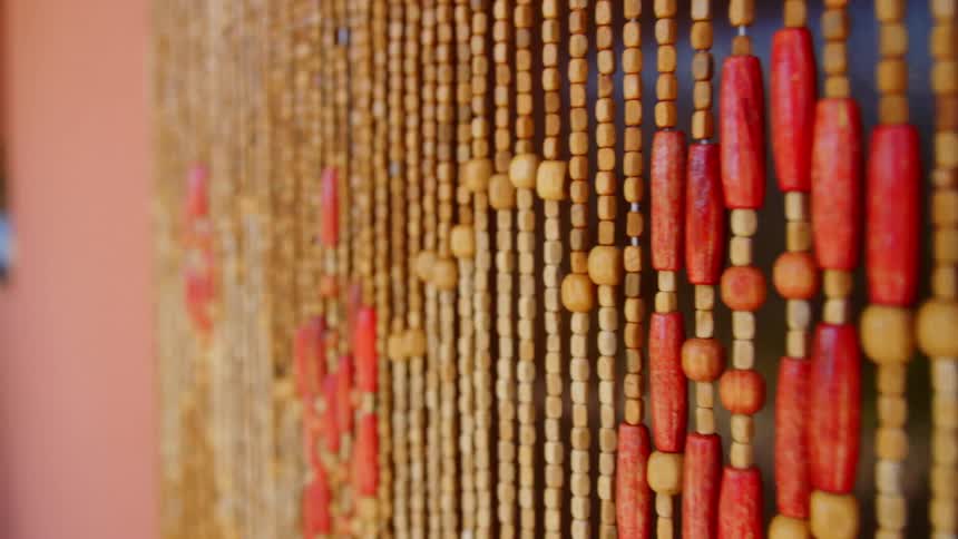 Beads hang in the doorway of a shop