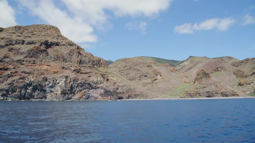 Mountains rise along a coastline
