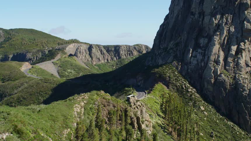 Bus drives on a road on the mountains