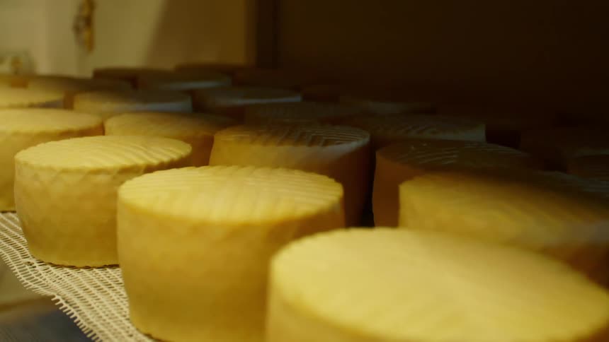 A shelf lined with cakes in a bakery