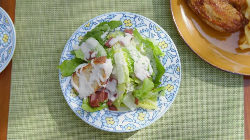 Birds eye view of a plate with salad and bread on it