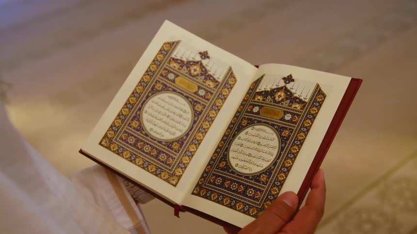 Man reads the koran the holy book of the islamic religion