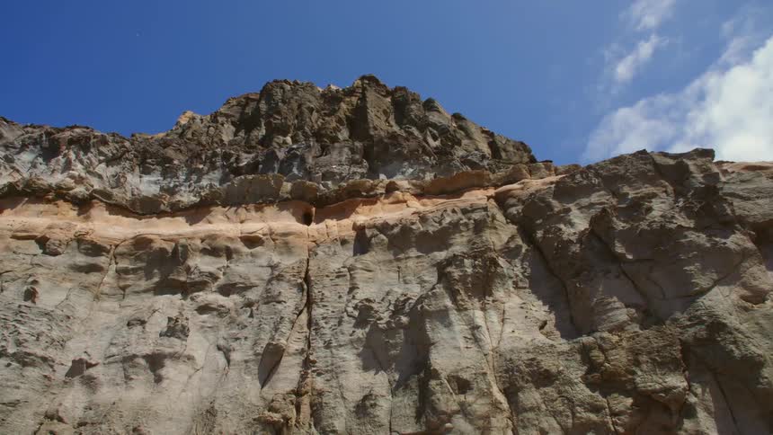 Cliff on a mountain under blue sky