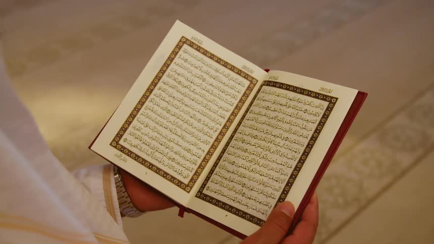 A man reads a book in an arabic language