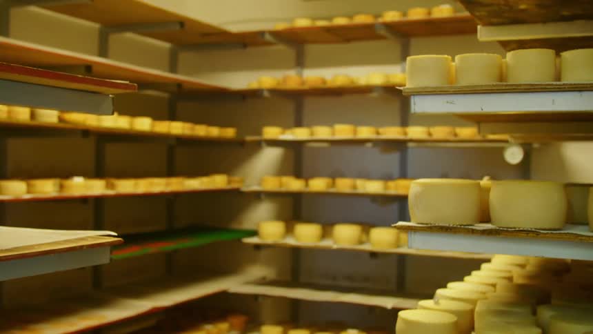 Shelves of pottery in a store supply room