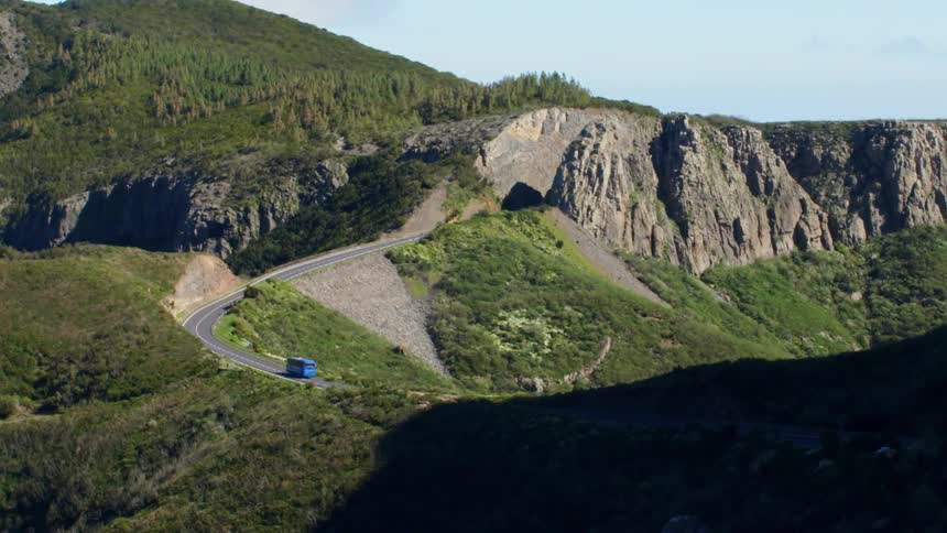 Bus climbing road on the mountains through a pass