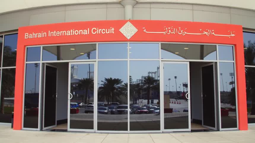 A buildings entrance consists of windows and four glass doors