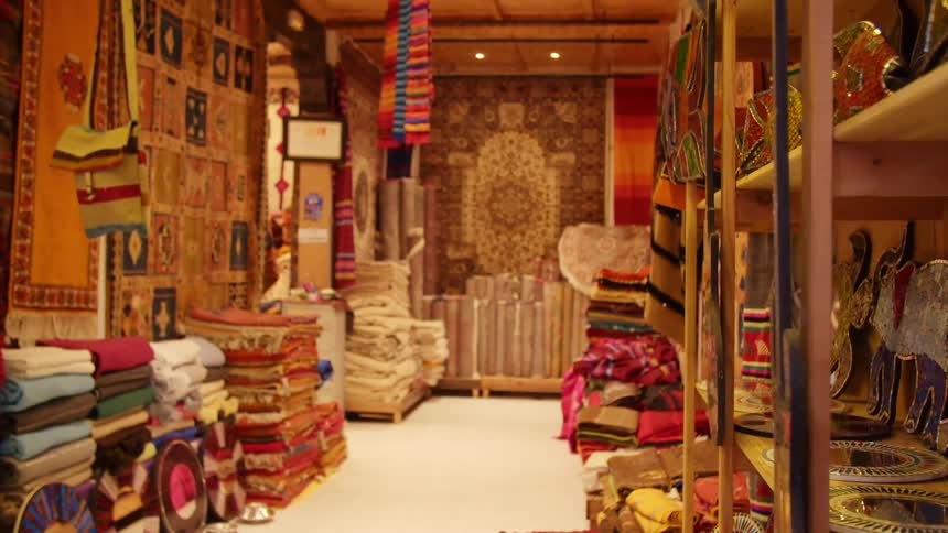 A store is filled with colorful tapestries and knick knacks