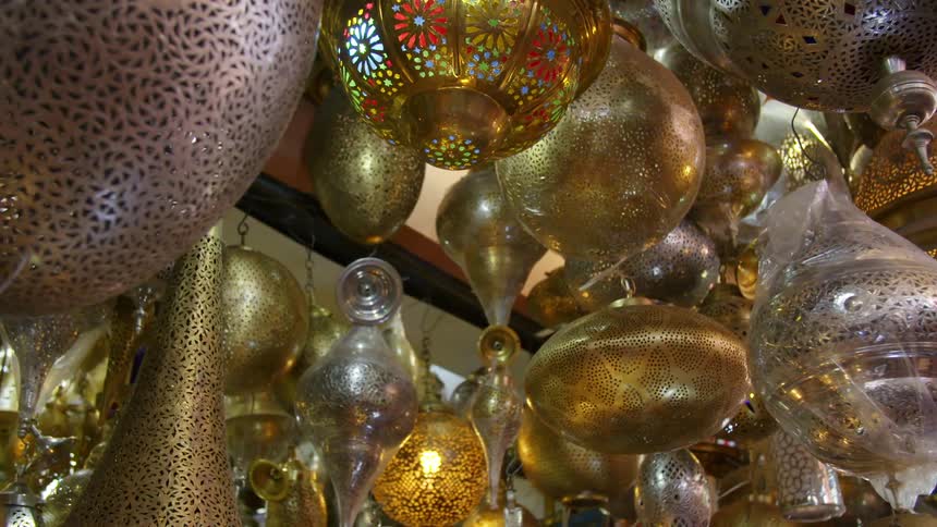 Ornaments and lights hanging from a ceiling in a market