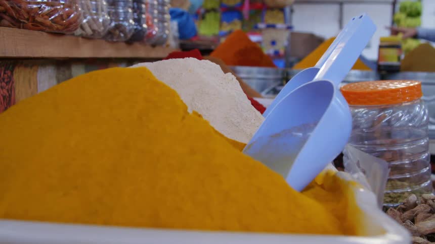 Boxes full of powdered spices in an open market