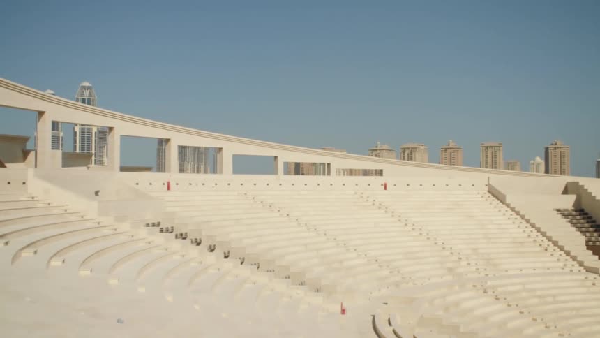 A stadium with buildings and skyscrapers in the background