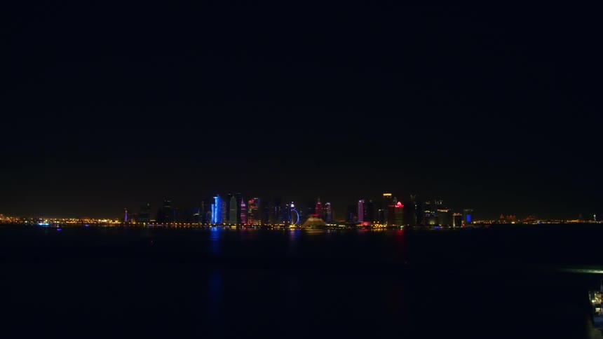 The downtown of a city twinkles with lights at night