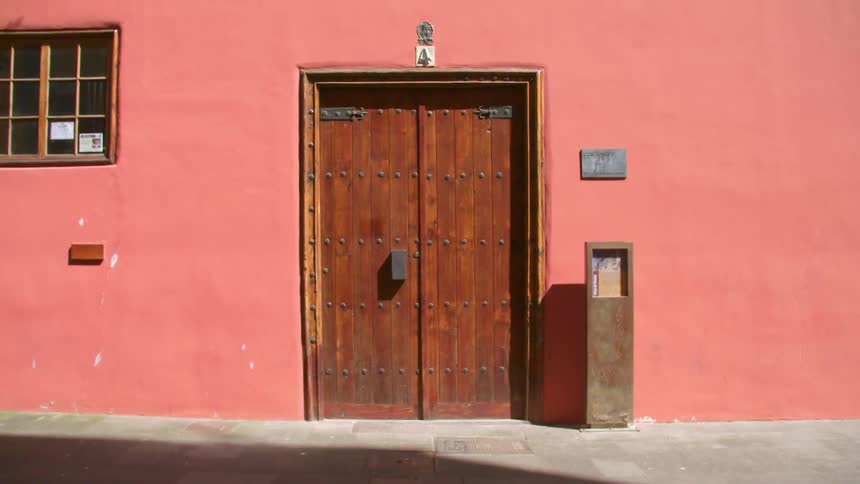 A wooden door on a brightly coloured building