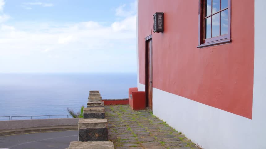 House in the tropics with flagstone walkway near the ocean
