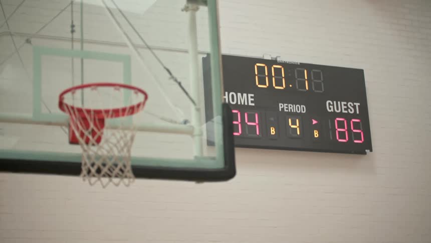 A scoreboard changes as a basket is scored