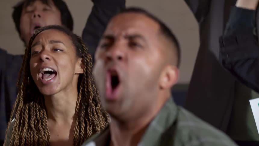A group of people yelling at a protest