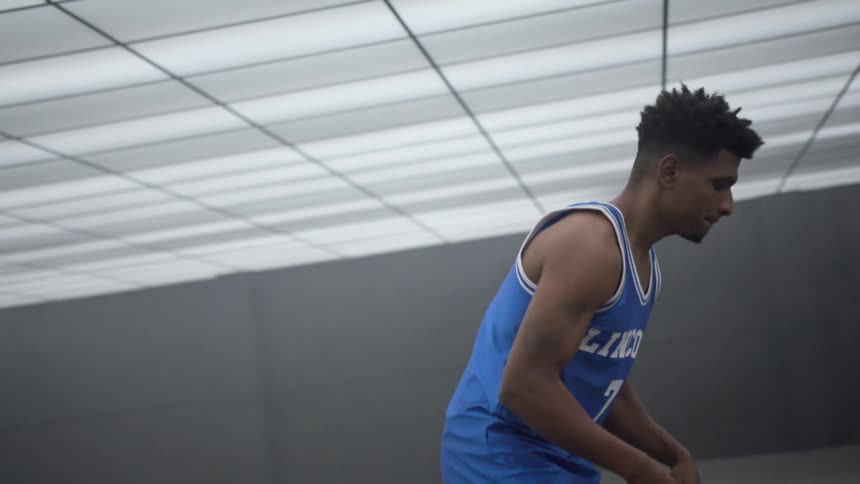 An athlete is playing basketball